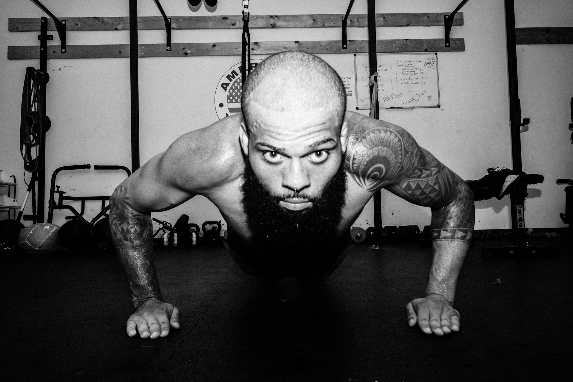 topless man in black shorts doing exercise
